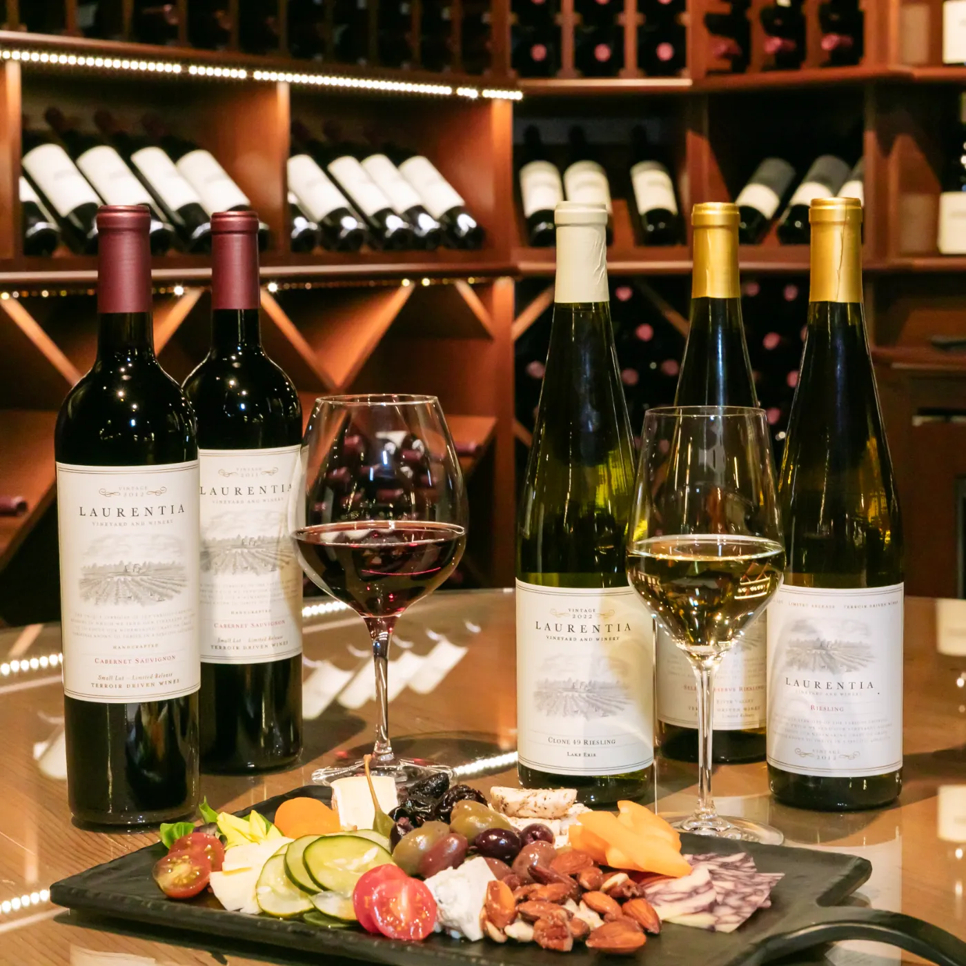 Photo of several wines on table with charcuterie board