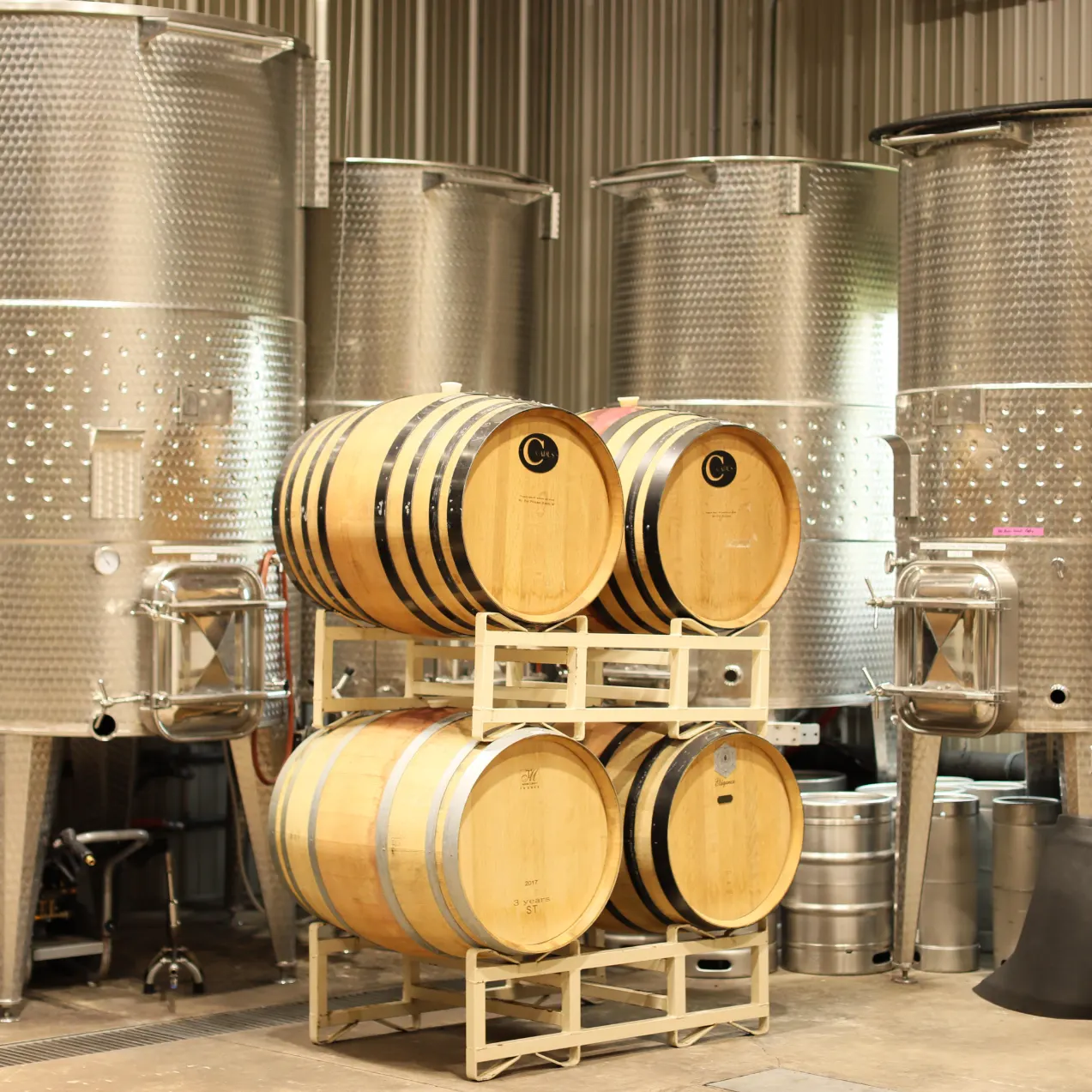 Oak barrels and stainless fermentation tanks in the Laurentia production facility