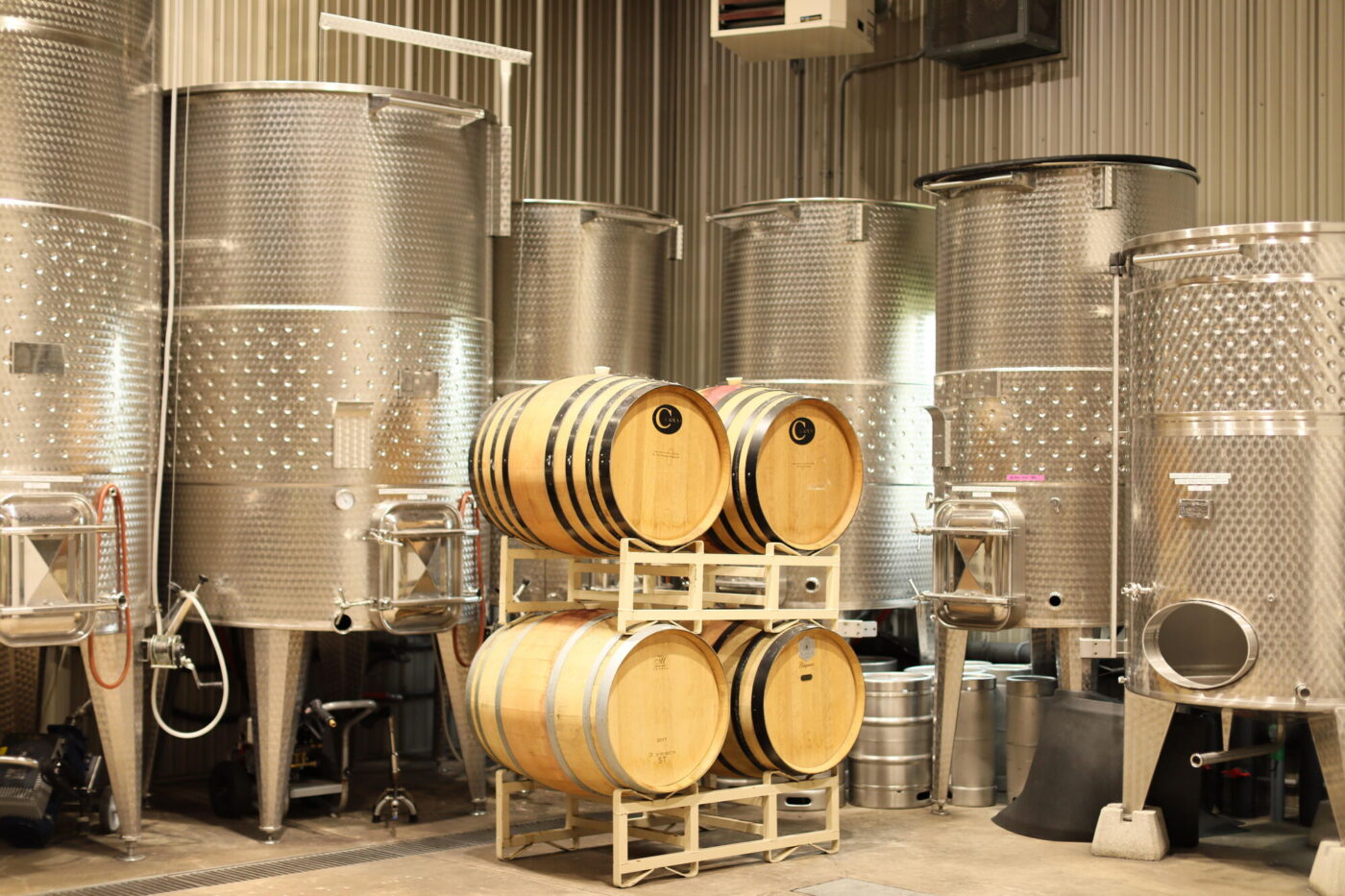 Oak barrels and stainless fermentation tanks in the Laurentia production facility